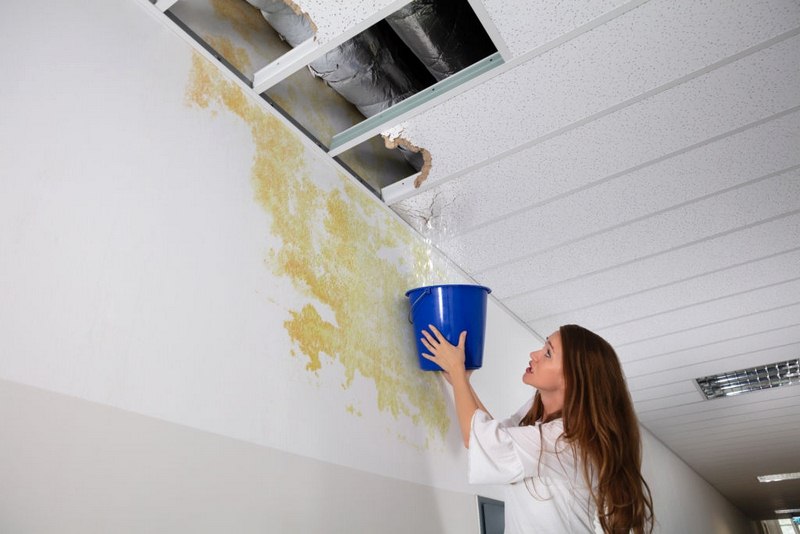 A woman dealing with a water leak in her wall