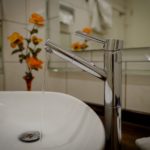 water running from the tap into a sink