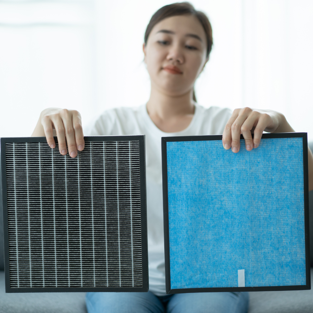 a woman holding up two hvac air filters