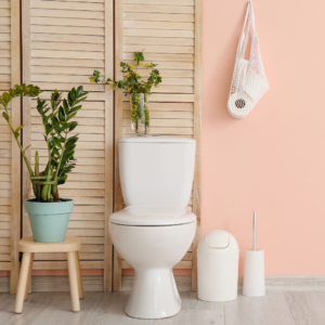 pink and wood bathroom with toilet