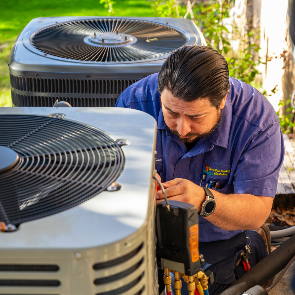 close up view of a tech working on an ac unit
