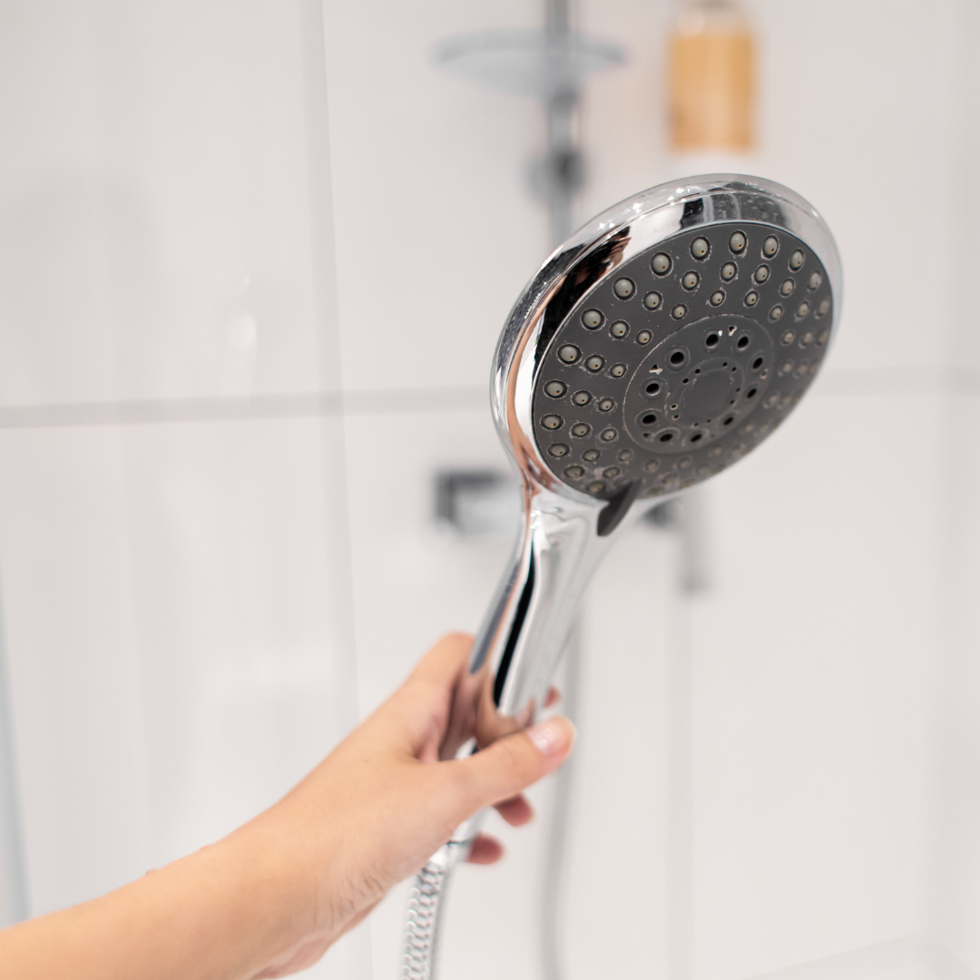 Someone holding a shower head
